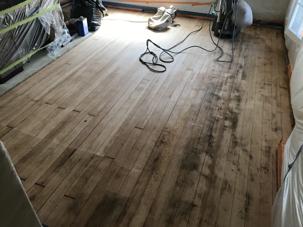 P.O.R.S. Sanding Hardwood floors before applying odor encapsulator.
