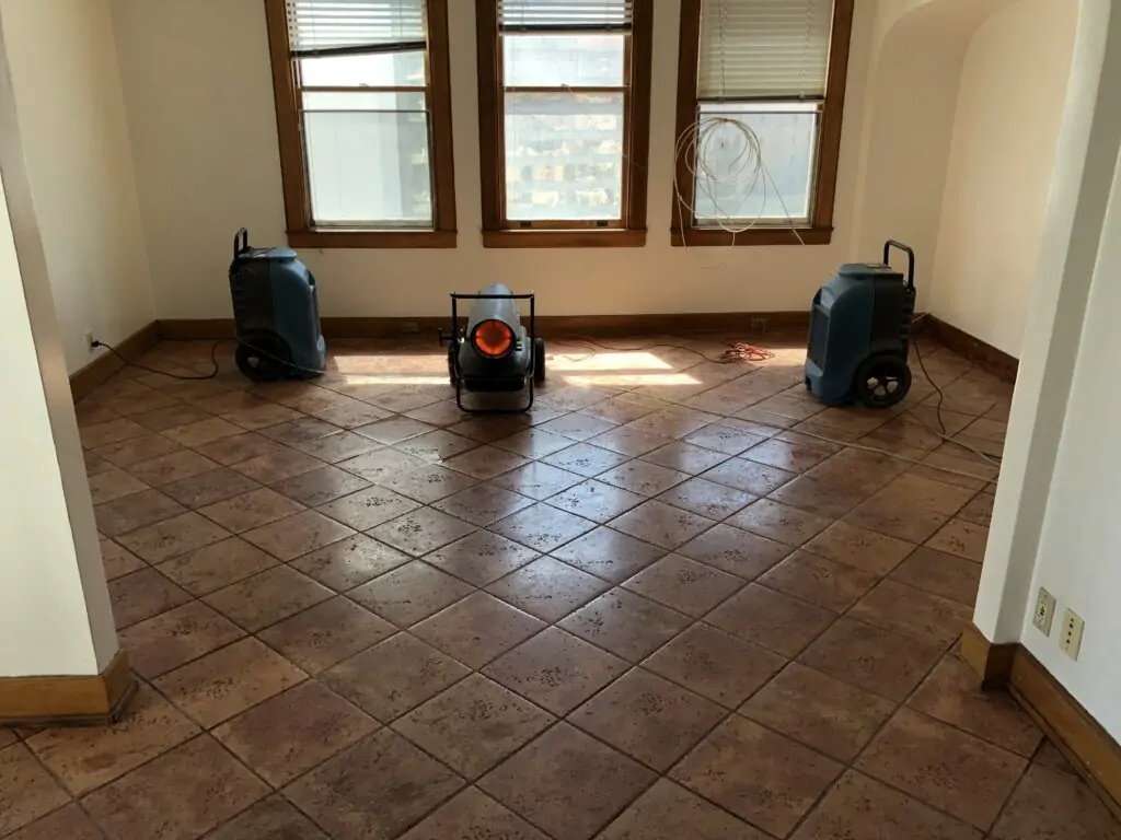 Tile floor being treated for urine odor by P.O.R.S.