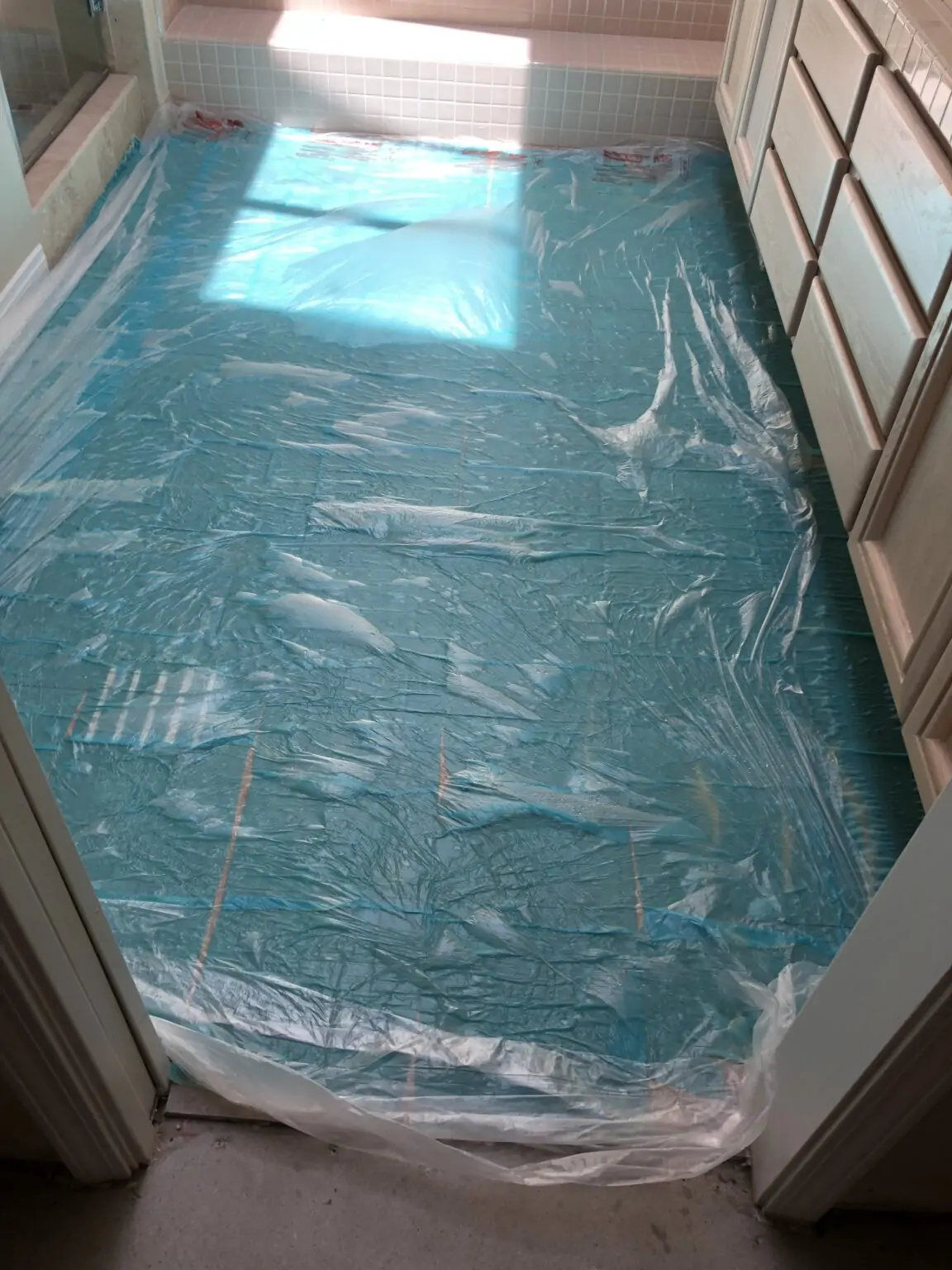 Tile floor being soak-treated to remove urine odor from grout