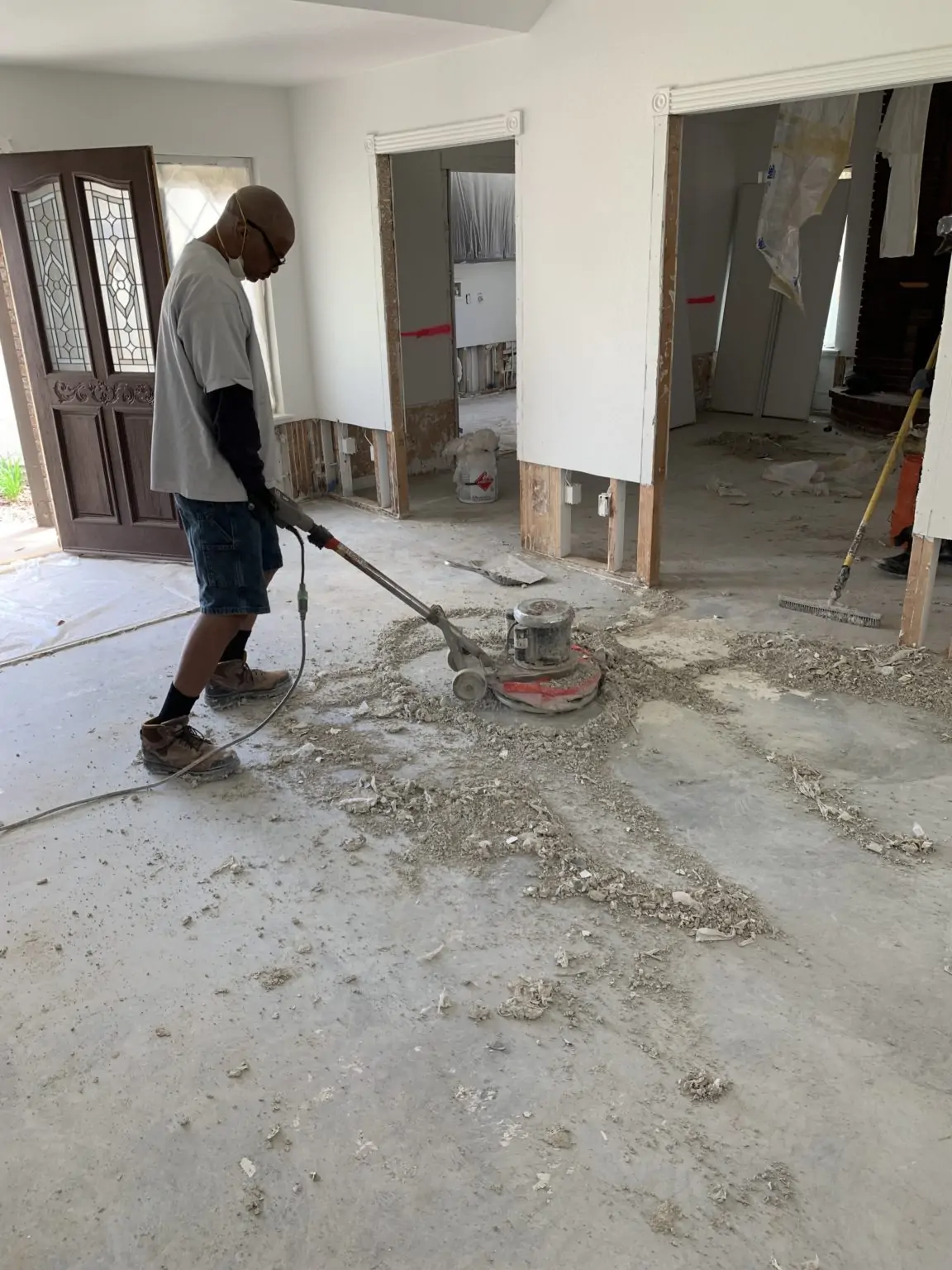 Subfloor being sanded to clean wood fiber before sealing